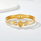 Multi four-leaf clover station and pave cubic zirconia accent stainless steel jewelry bangle in waterproof 18k gold plated finish.