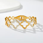Multi four-leaf clover station and pave cubic zirconia accent stainless steel jewelry bangle in waterproof 18k gold plated finish.