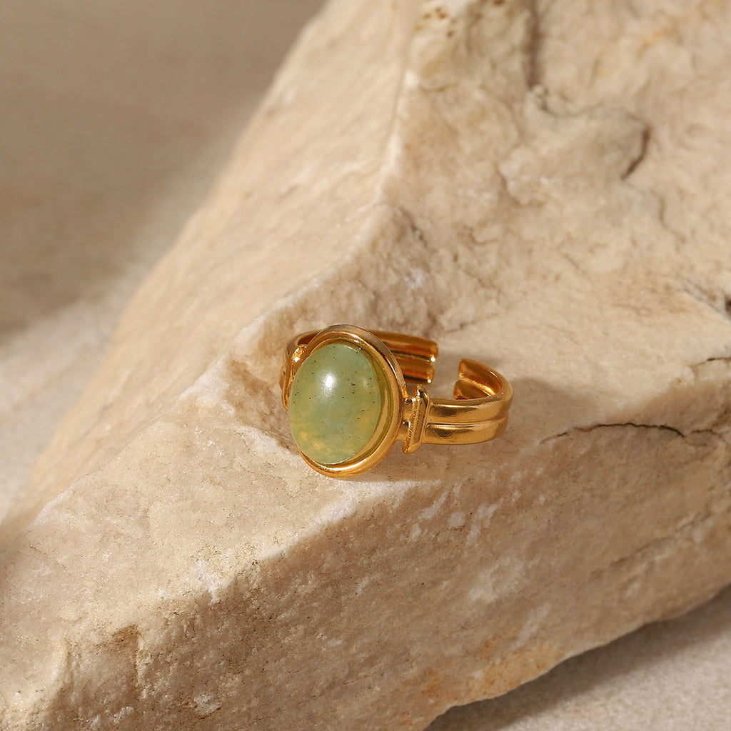 Oval light green cabochon aventurine jade stone open cuff adjustable band stainless steel jewelry ring in waterproof 18k gold plated finish.