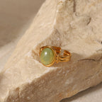 Oval light green cabochon aventurine jade stone open cuff adjustable band stainless steel jewelry ring in waterproof 18k gold plated finish.