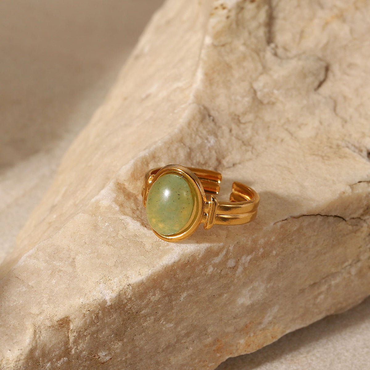 Oval light green cabochon aventurine jade stone open cuff adjustable band stainless steel jewelry ring in waterproof 18k gold plated finish.