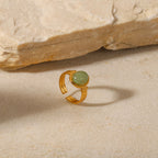 Oval light green cabochon aventurine jade stone open cuff adjustable band stainless steel jewelry ring in waterproof 18k gold plated finish.
