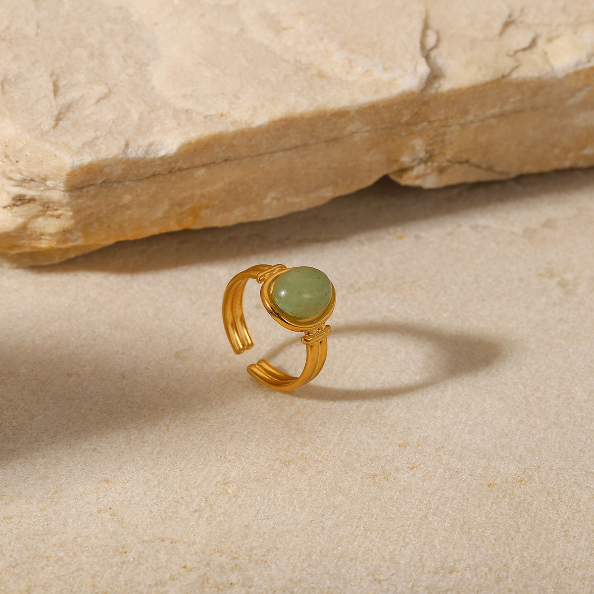 Oval light green cabochon aventurine jade stone open cuff adjustable band stainless steel jewelry ring in waterproof 18k gold plated finish.