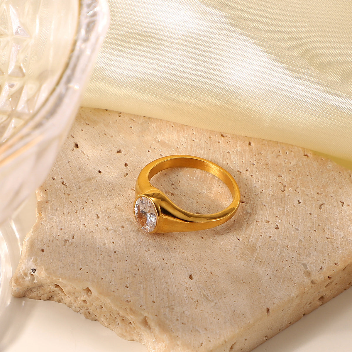 Oval solitaire clear cubic zirconia cz crystal bezel set chunky dome signet ring stainless steel jewelry in waterproof 18k gold plated finish.