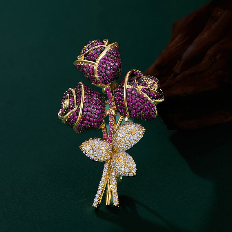 Elegant floral bouquet brooch with purple and blue cubic zirconia petals and a sparkling silver-tone stem