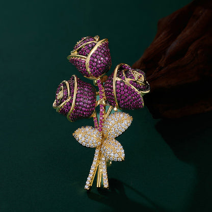 Elegant floral bouquet brooch with purple and blue cubic zirconia petals and a sparkling silver-tone stem