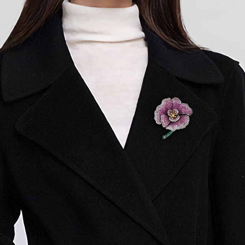 Elegant camellia brooch with purple gradient cubic zirconia petals, a golden stamen, and a green stem