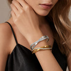 Engraved Roman numeral and pave cubic zirconia crossover stainless steel bangle bracelet jewelry in waterproof 18k gold plated finish.