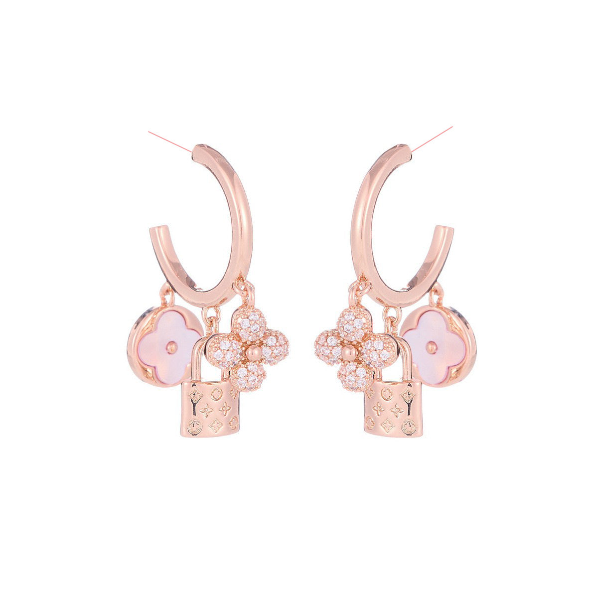 Rose gold huggie hoop earrings featuring a sparkling zirconia pave and a delicate four-leaf clover charm