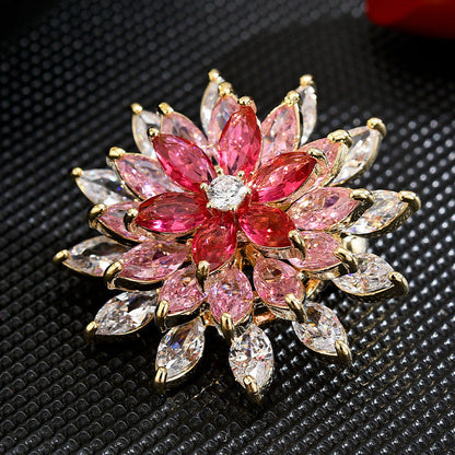 Sparkling rotating sunflower brooch featuring pink gradient marquise cubic zirconia stones in 18K gold plating