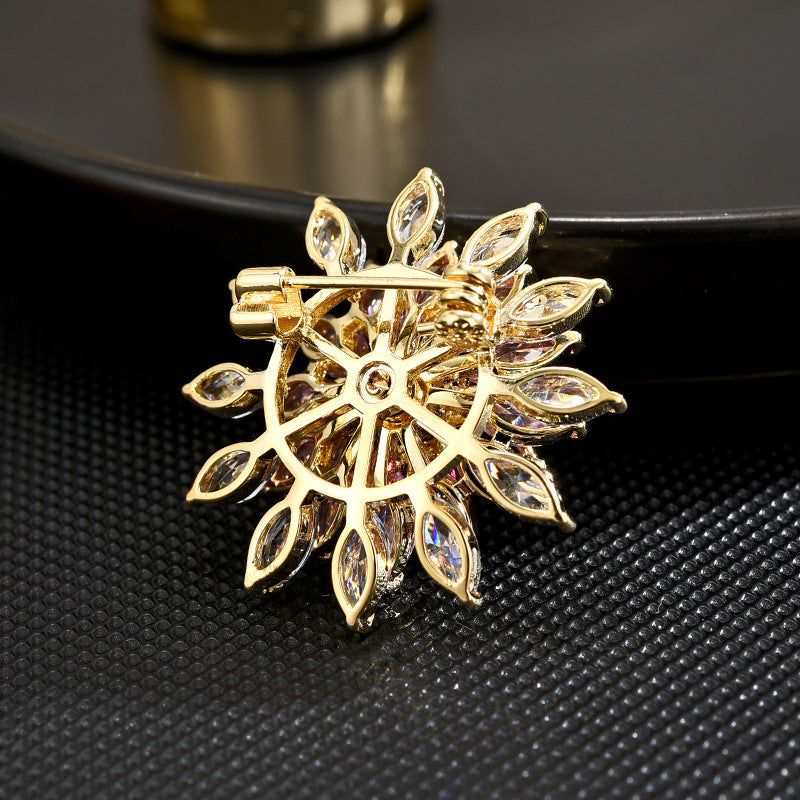 Sparkling rotating sunflower brooch featuring pink gradient marquise cubic zirconia stones in 18K gold plating