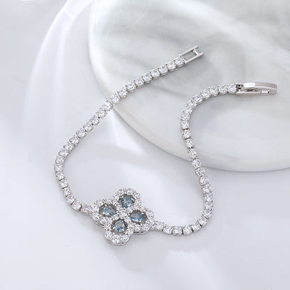 S925 sterling silver tennis bracelet with a four-leaf clover halo charm featuring sparkling cubic zirconia