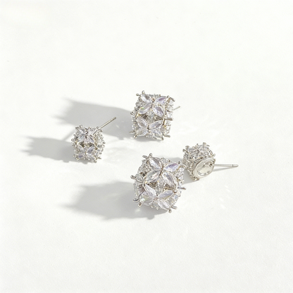 Minimalist S925 silver cube stud earrings featuring a sparkling central zirconia, available in gold and silver