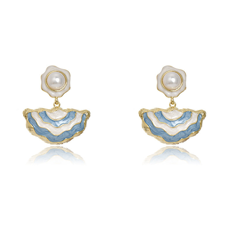 Gold S925 silver drop earrings featuring blue enamel studs and elegant dangling white pearls with a handmade finish