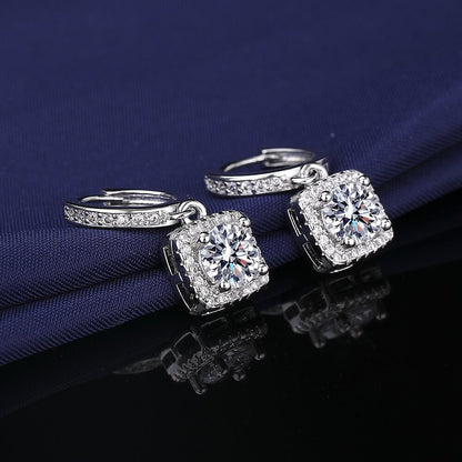 S925 sterling silver stud earrings featuring a brilliant round zirconia center with a sparkling halo pave border
