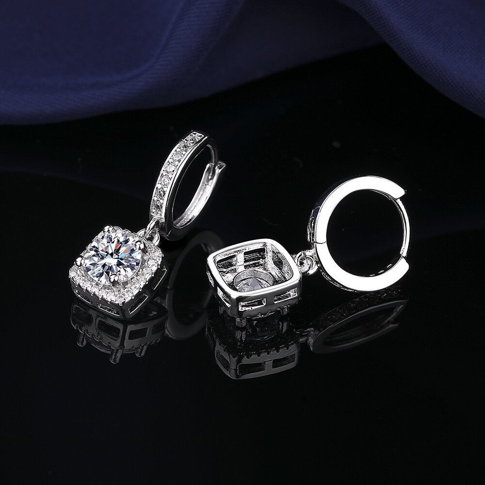 S925 sterling silver stud earrings featuring a brilliant round zirconia center with a sparkling halo pave border