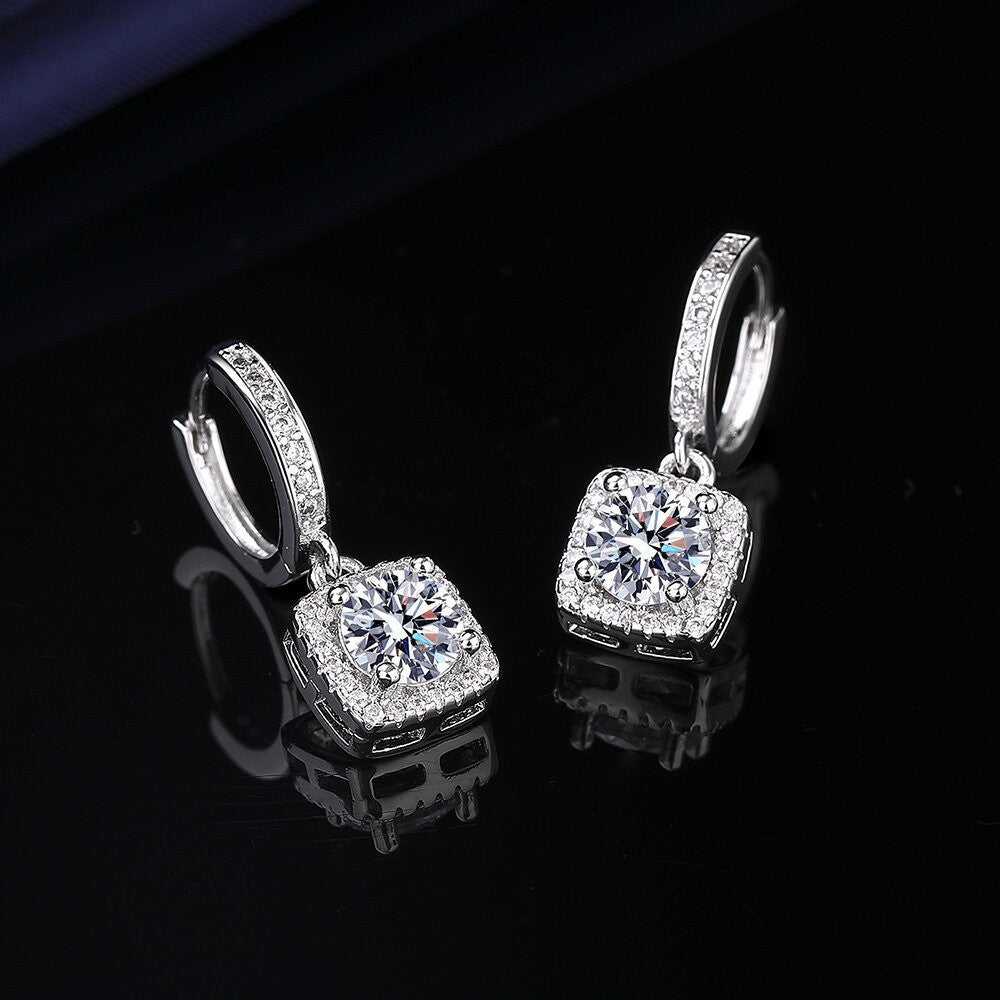 S925 sterling silver stud earrings featuring a brilliant round zirconia center with a sparkling halo pave border