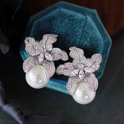 Elegant S925 sterling silver lily flower stud earrings featuring a lustrous white pearl center in a silver tone