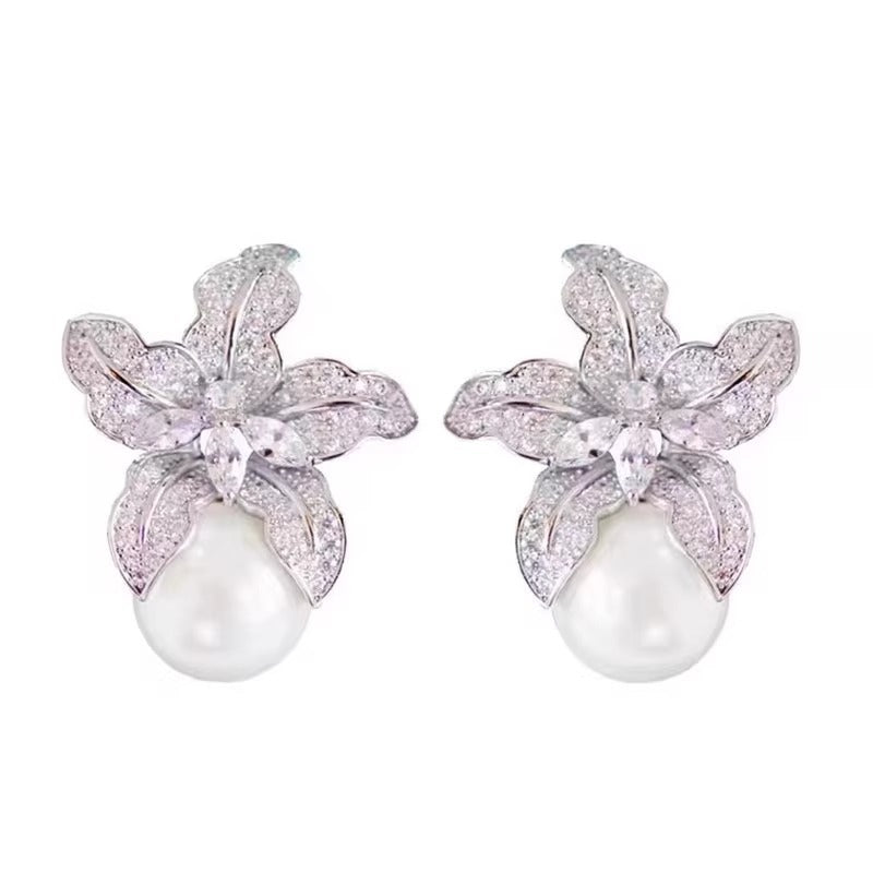 Elegant S925 sterling silver lily flower stud earrings featuring a lustrous white pearl center in a silver tone