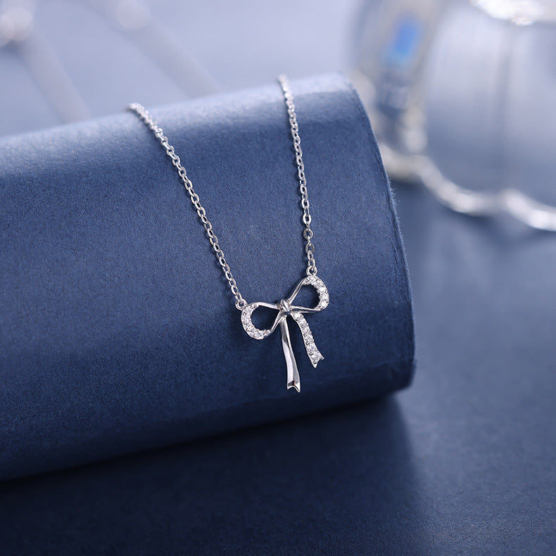 Minimalist S925 sterling silver bowknot pendant necklace featuring a delicate ribbon design for a romantic look