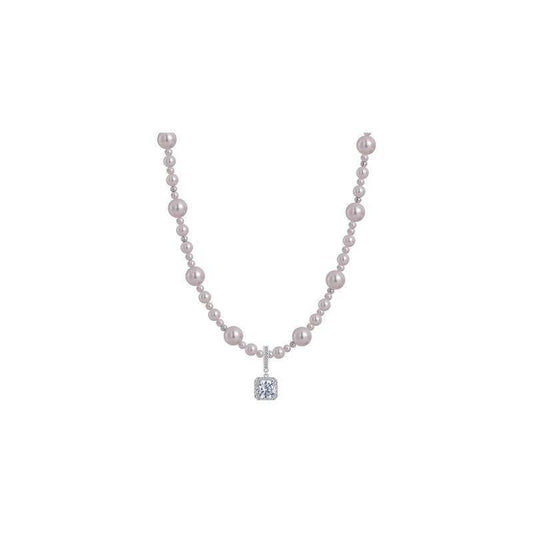 Modern silver-tone necklace featuring a sleek arc pendant with a dangling round pearl and shimmering zircon accents