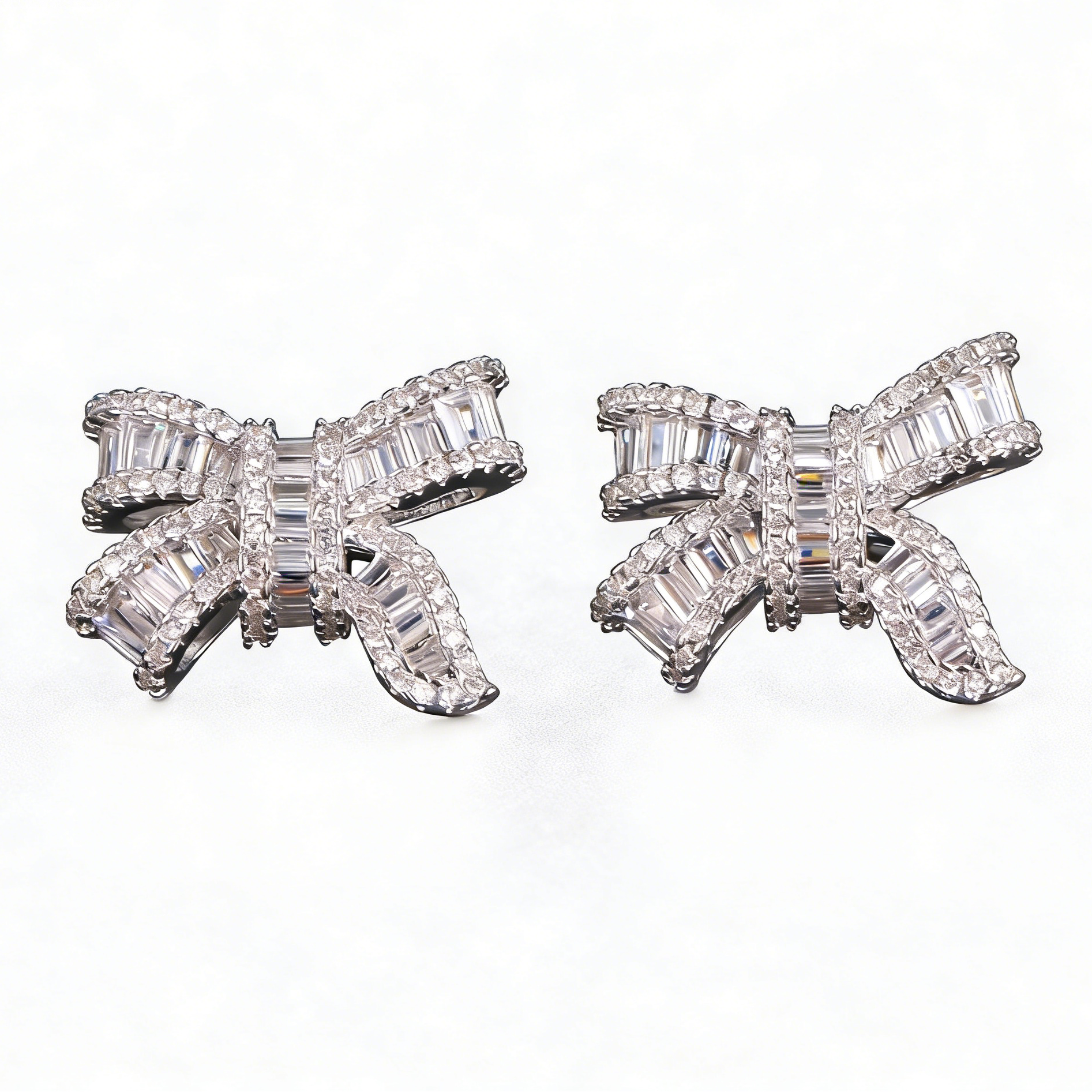 Silver bowknot stud earrings featuring a delicate ribbon design fully set with sparkling clear zirconia stones