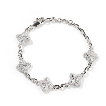 Elegant silver four-leaf clover bangle with pink and green gemstone centers surrounded by a sparkling zirconia halo