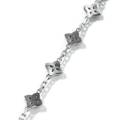 Elegant silver four-leaf clover bangle with pink and green gemstone centers surrounded by a sparkling zirconia halo