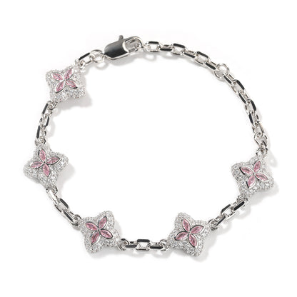 Elegant silver four-leaf clover bangle with pink and green gemstone centers surrounded by a sparkling zirconia halo