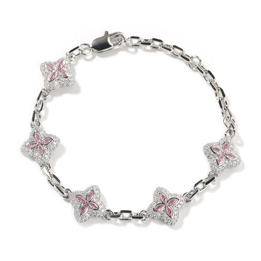 Elegant silver four-leaf clover bangle with pink and green gemstone centers surrounded by a sparkling zirconia halo