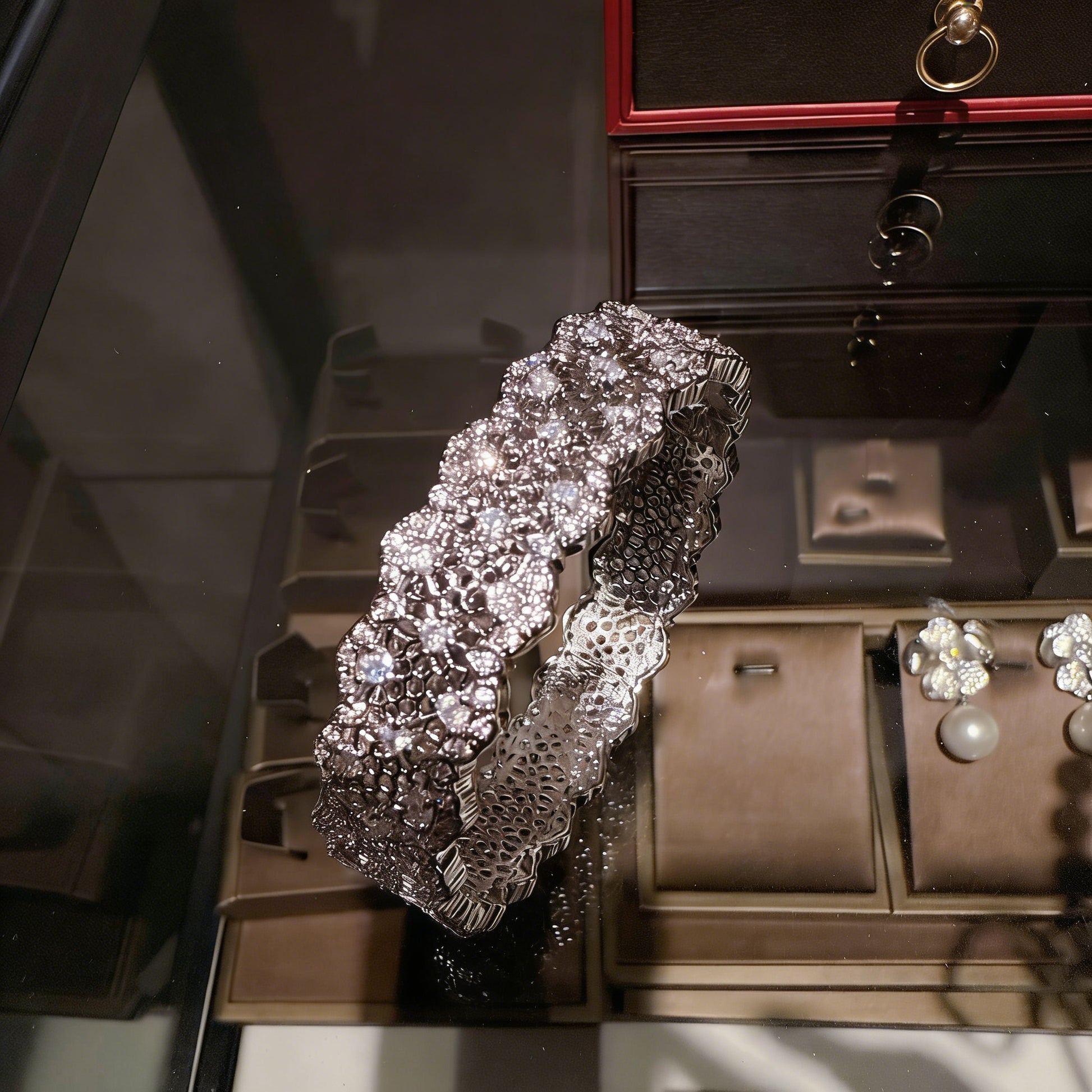 Elegant silver bangle with an intricate lace-inspired cutout pattern and sparkling white cubic zirconia