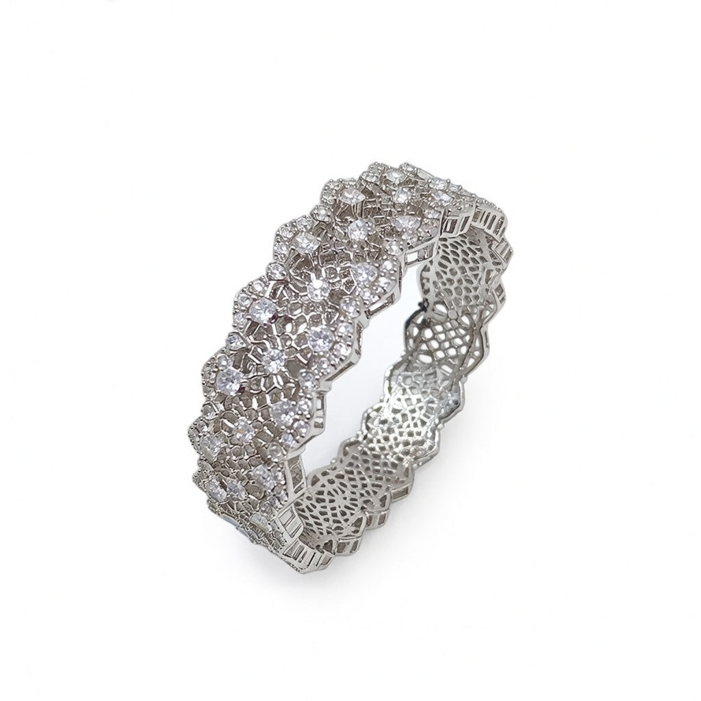 Elegant silver bangle with an intricate lace-inspired cutout pattern and sparkling white cubic zirconia