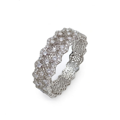 Elegant silver bangle with an intricate lace-inspired cutout pattern and sparkling white cubic zirconia