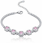 Elegant silver tennis bracelet with a pink round halo center stone and sparkling white cubic zirconia