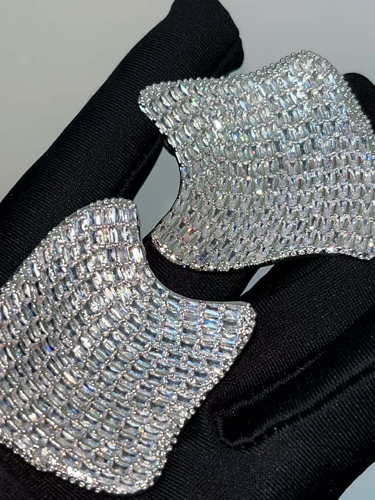 Silver huggie hoop earrings with a continuous row of sparkling clear zirconia stones in a pave setting
