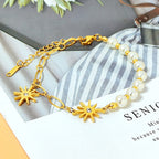 Starburst crystal charms round pearl bead strand paperclip link chain stainless steel jewelry bracelet in waterproof 18k gold plated finish.