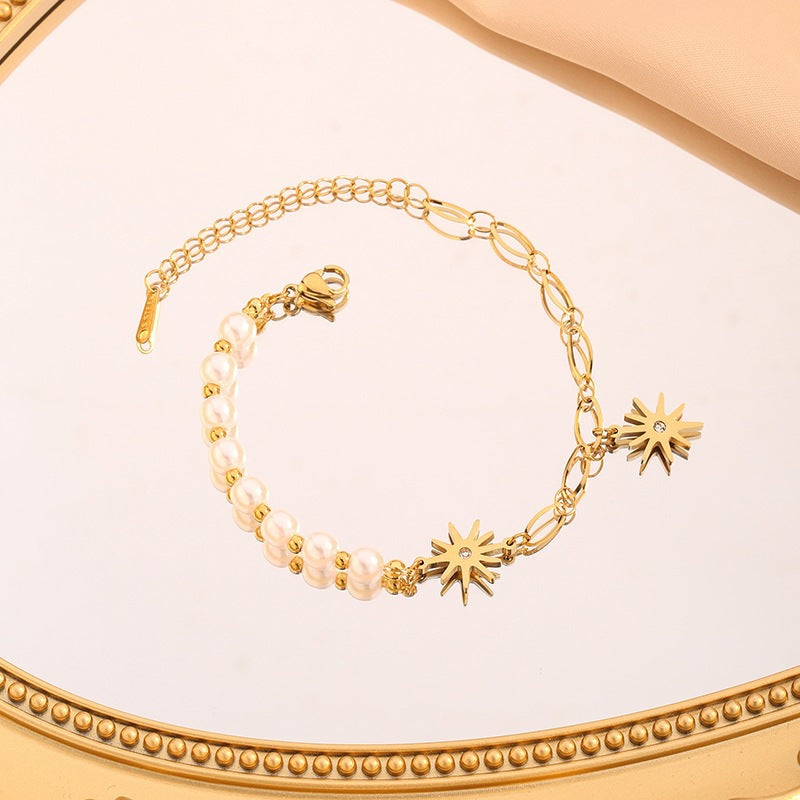 Starburst crystal charms round pearl bead strand paperclip link chain stainless steel jewelry bracelet in waterproof 18k gold plated finish.