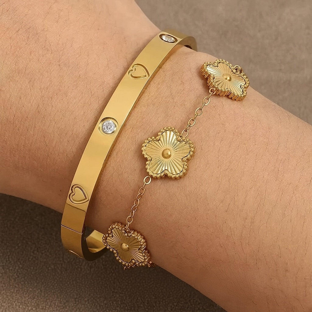 Engraved heart and bezel-set cubic zirconia hinged cuff bangle in waterproof 18k gold plated stainless steel jewelry.