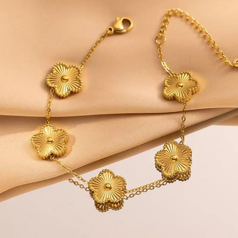 Engraved heart and bezel-set cubic zirconia hinged cuff bangle in waterproof 18k gold plated stainless steel jewelry.