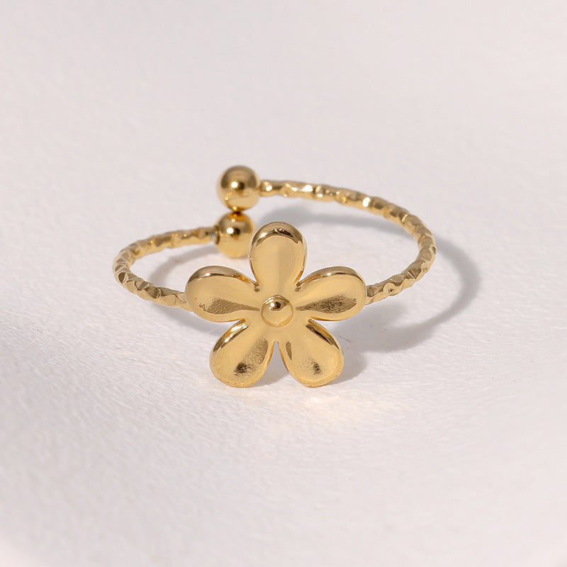 Textured open cuff floral band with flower motif stainless steel jewelry ring in waterproof 18k gold plated finish.