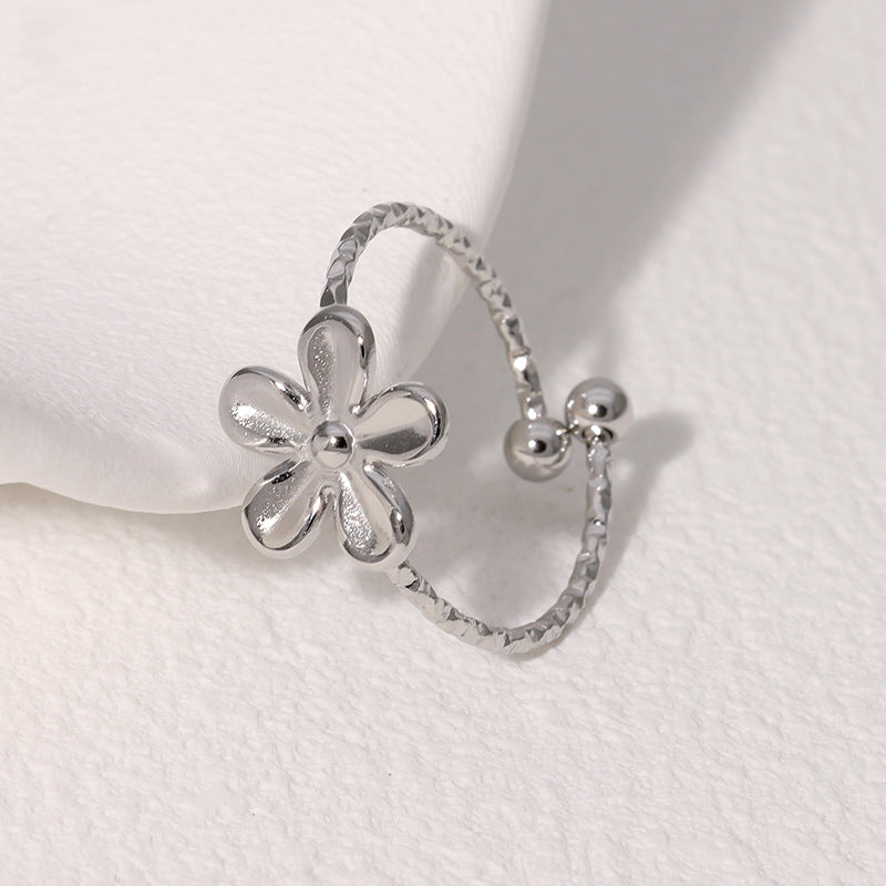 Textured open cuff floral band with flower motif stainless steel jewelry ring in waterproof 18k gold plated finish.