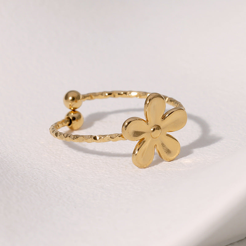 Textured open cuff floral band with flower motif stainless steel jewelry ring in waterproof 18k gold plated finish.