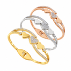 Triple heart station and pave cubic zirconia accent hinged cuff bangle in waterproof 18k gold plated stainless steel jewelry.