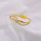 Triple heart station and pave cubic zirconia accent hinged cuff bangle in waterproof 18k gold plated stainless steel jewelry.