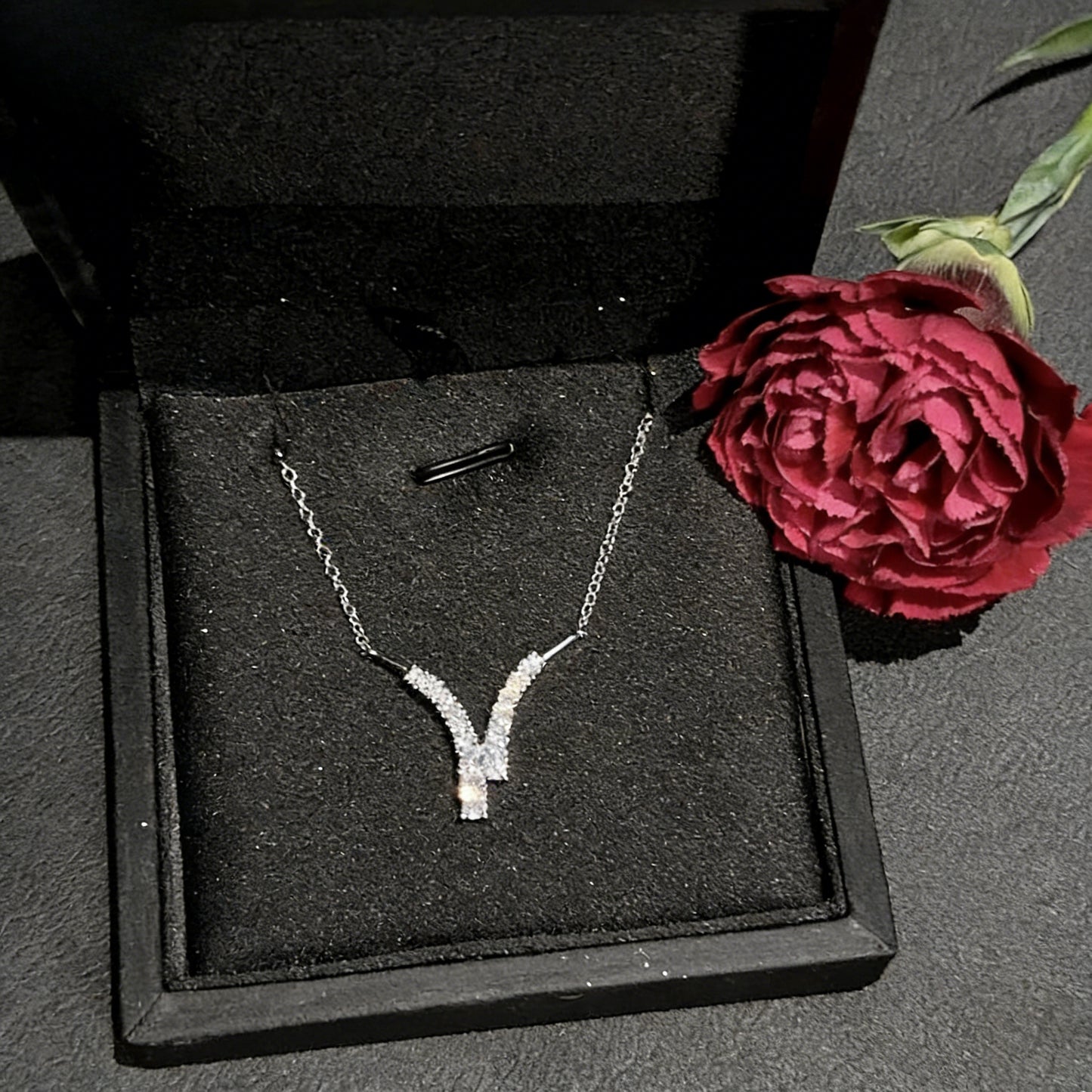 Elegant V-shaped horn pendant necklace featuring sparkling cubic zirconia stones in a minimalist design