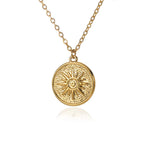 Vintage-inspired gold sun medallion pendant necklace with a textured celestial sunburst design and polished finish