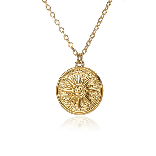 Vintage-inspired gold sun medallion pendant necklace with a textured celestial sunburst design and polished finish