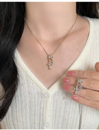 Waterproof stainless steel jewelry collection featuring champagne gold hypoallergenic gold plated double cross CZ pave pendant necklace.
