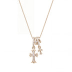 Waterproof stainless steel jewelry collection featuring champagne gold hypoallergenic gold plated double cross CZ pave pendant necklace.