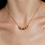 Waterproof stainless steel jewelry collection featuring 18k gold plated disc bead pave crystal tassel pendant necklace